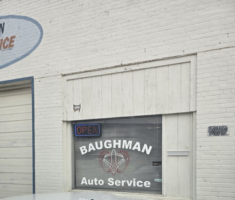 Baughman Auto Service storefront with neon OPEN sign at 410 N Washington St, Hutchinson